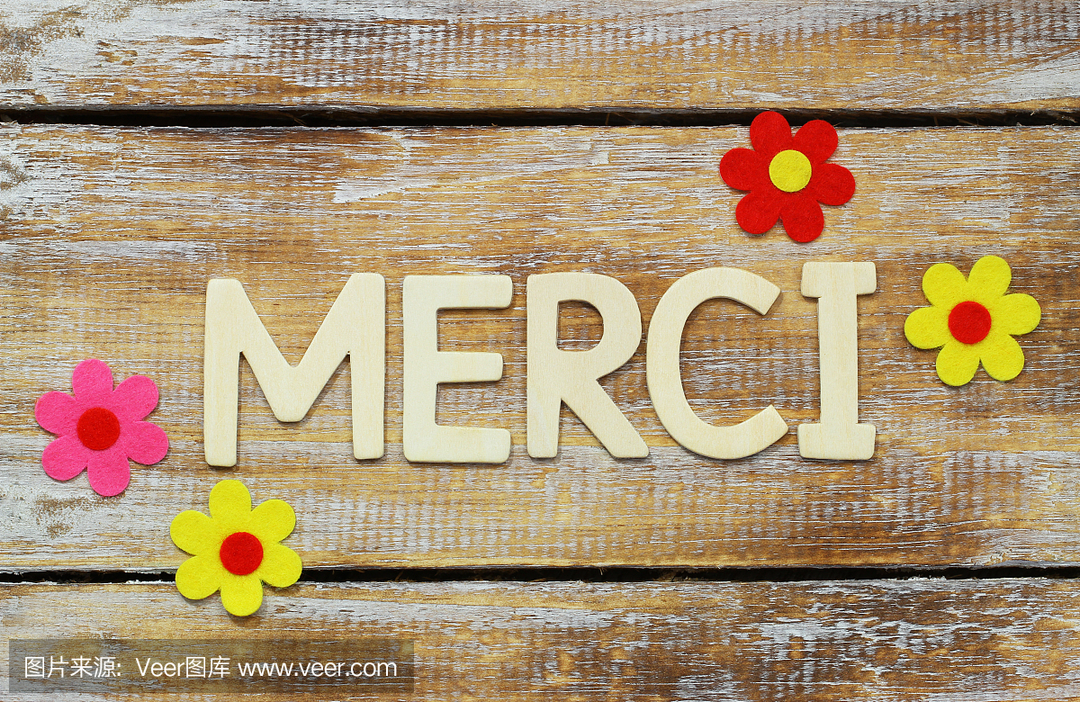 Merci (thank you in French) written with wooden