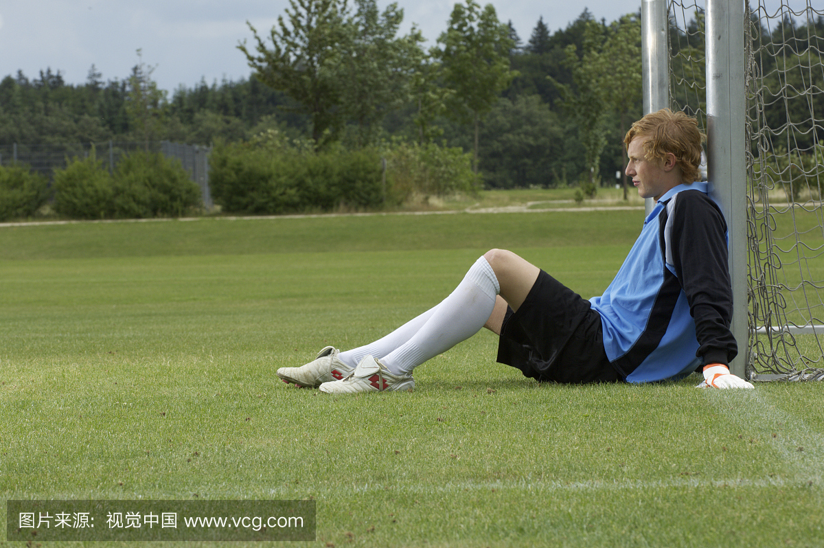 守门员靠在足球场上的目标