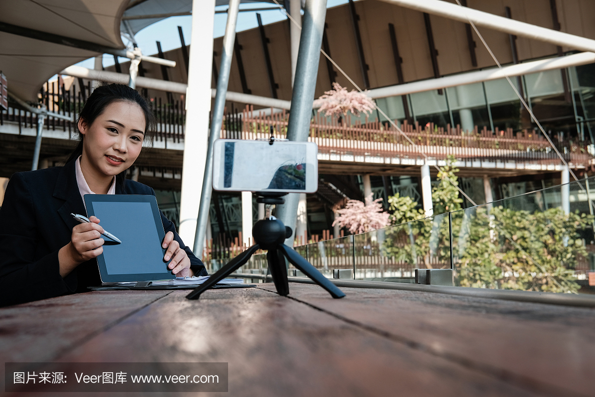 女实业家使用智能手机在线直播。女人录制视频