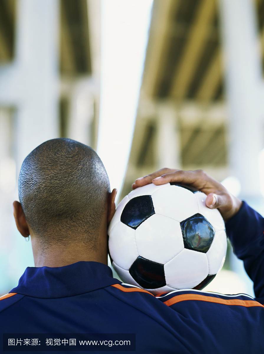 持有足球的男子的后视图