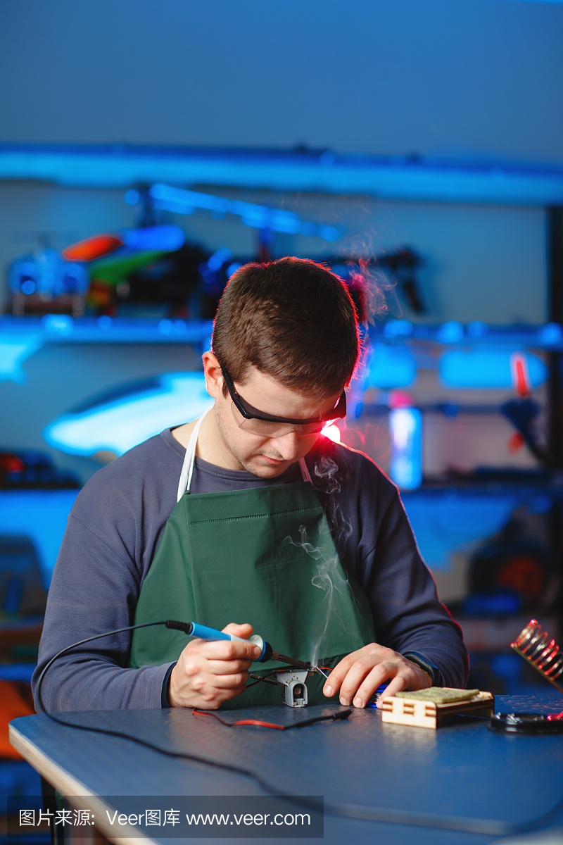 年轻男性工程师或技术员修理焊接无人机细节。