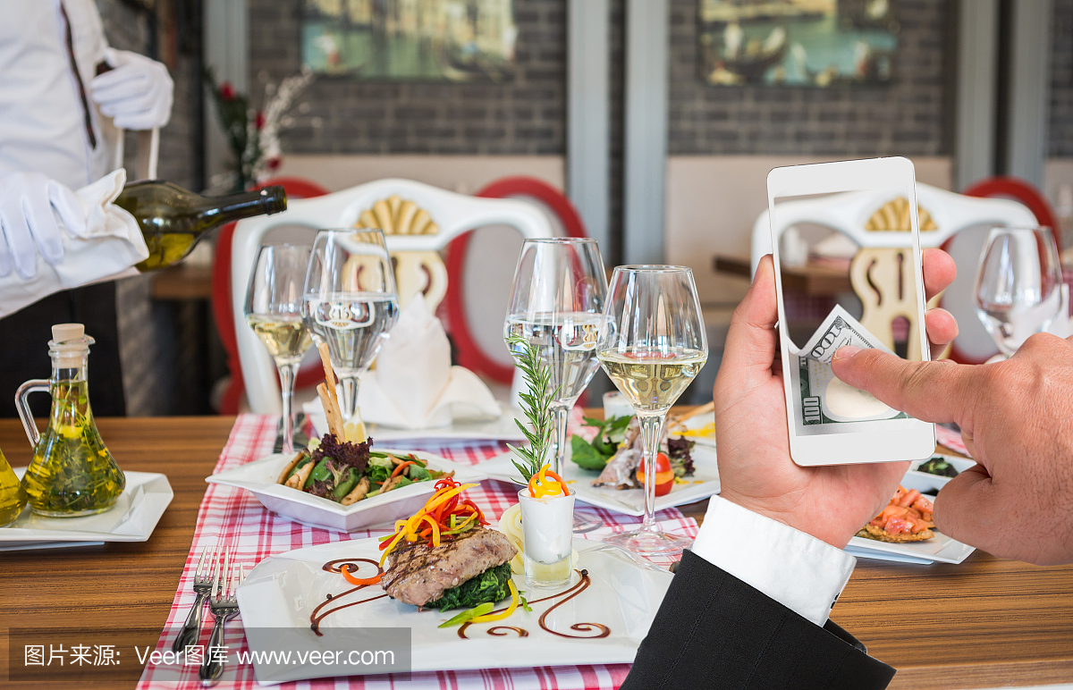 准备餐桌商人使用智能手机与网上支付
