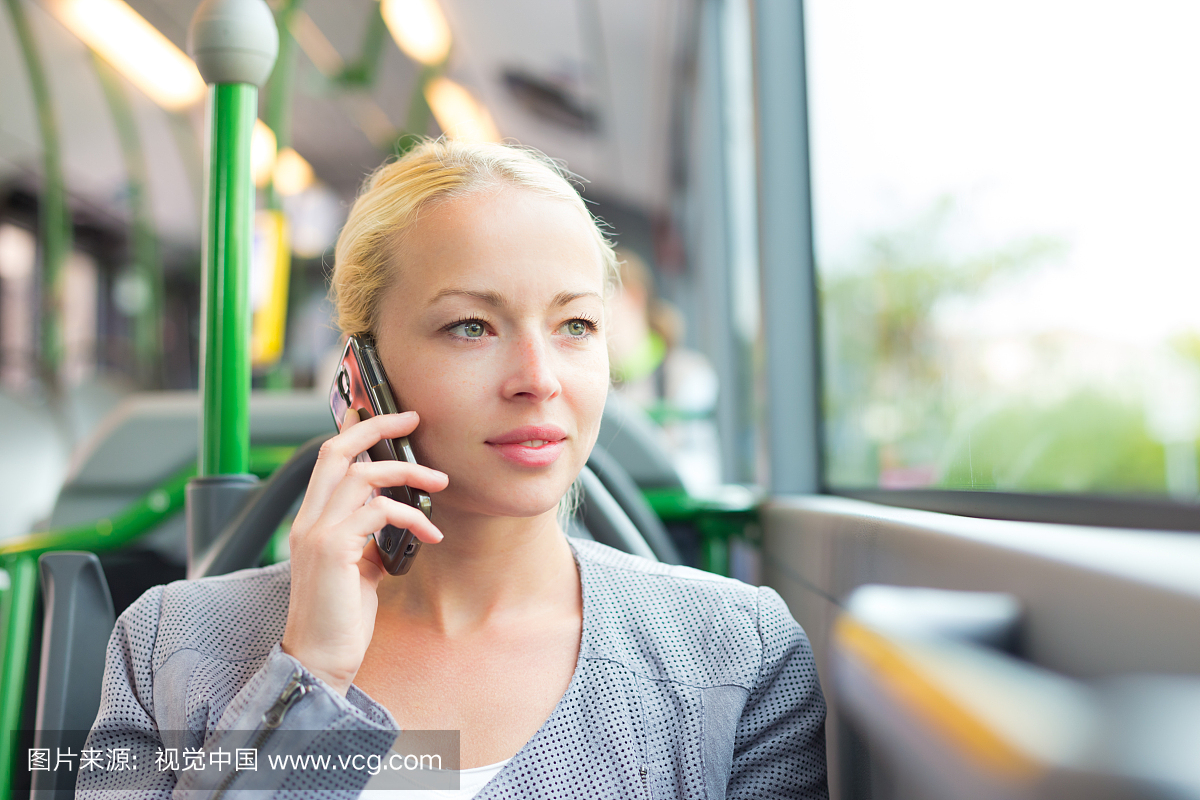 Blonde business woman traveling by bus.