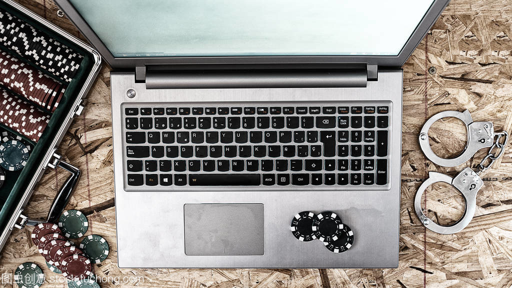 Online poker playing with laptop with wooden b Online poker playing with laptop with wooden b