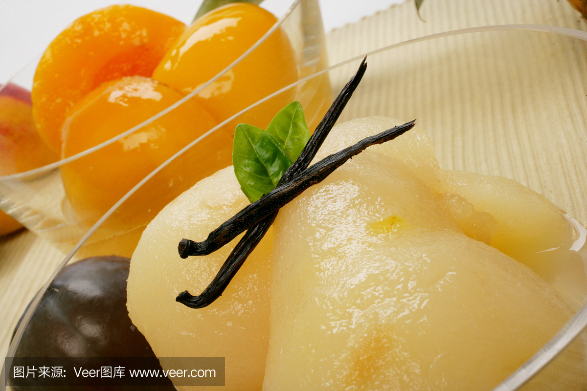 煮熟的梨和杏子在玻璃碗里