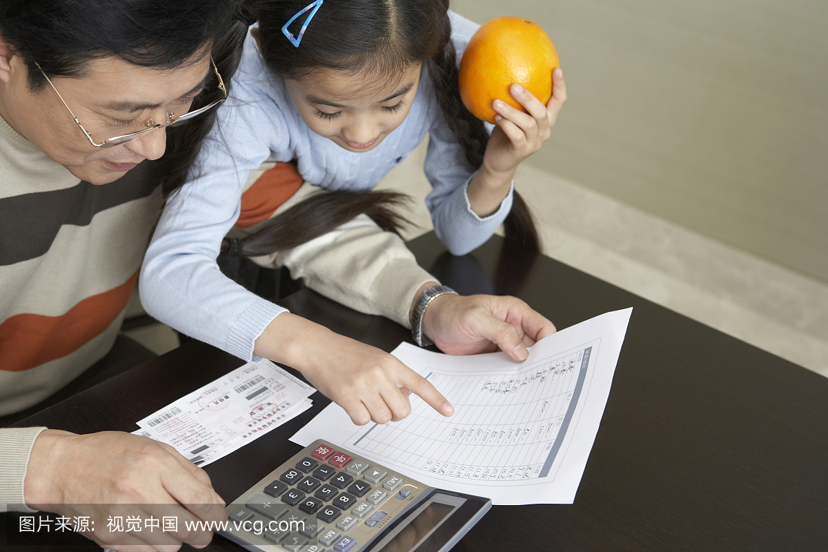 小女孩和父亲使用计算器