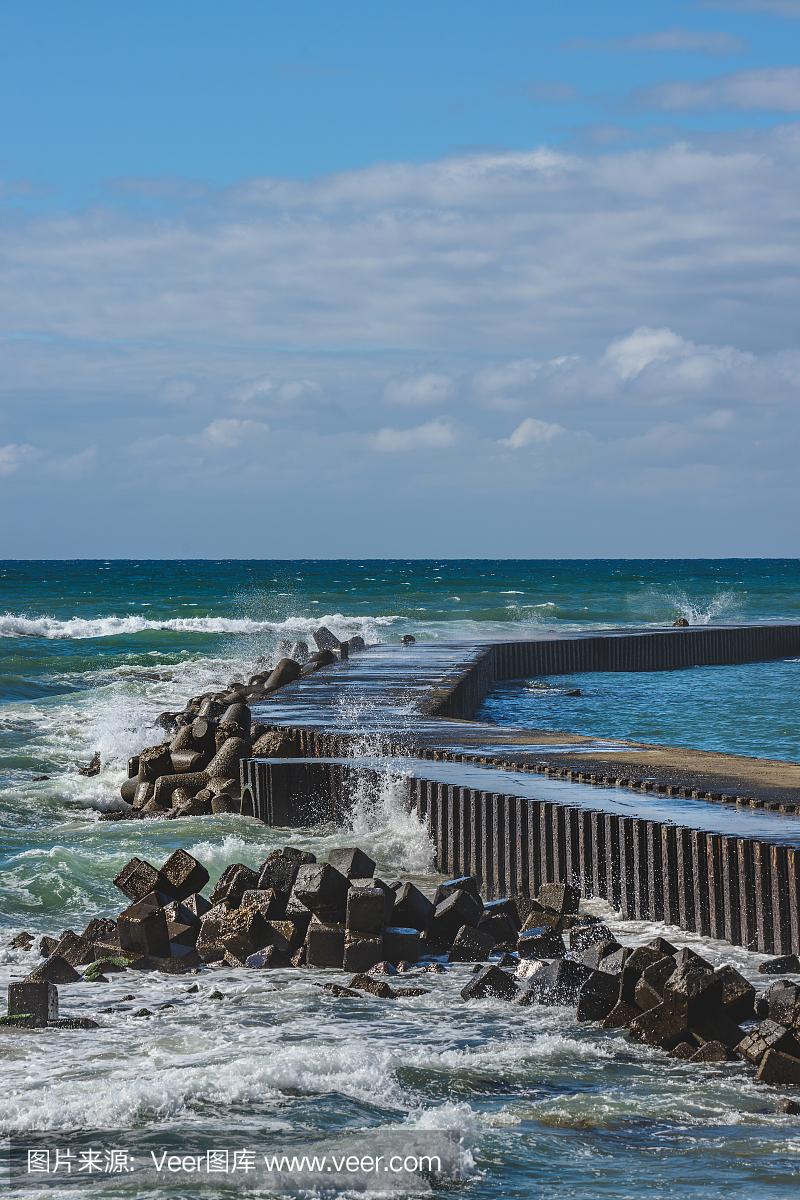 The waves beating the breakwater