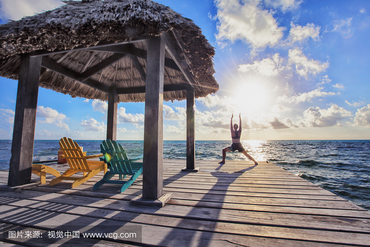 oman on vacation in Belize, practicing yoga on 