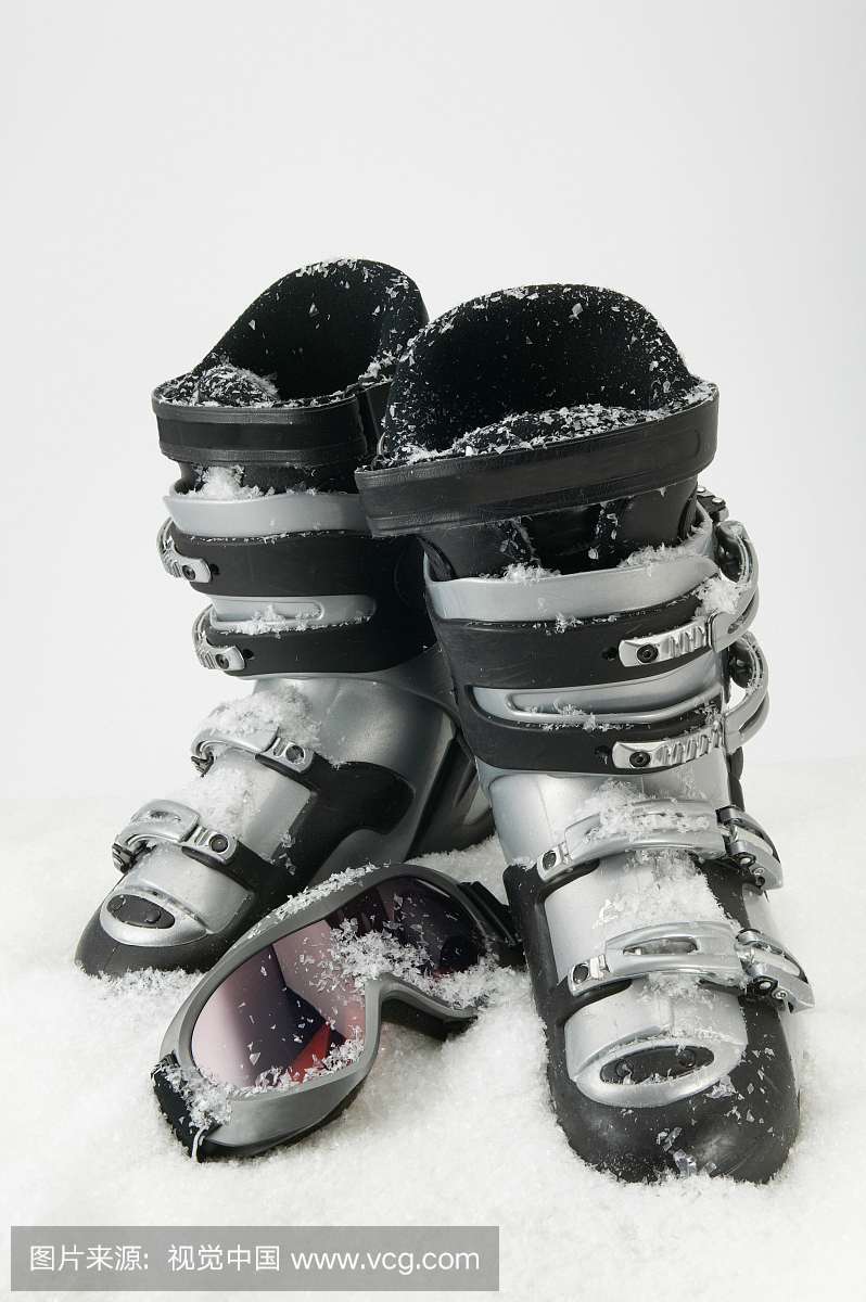 Detail view of a pair of ski boots and a ski gogg