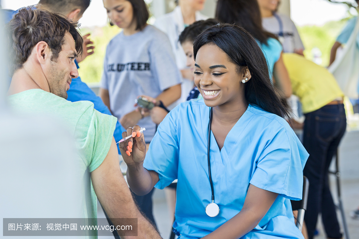 微笑的护士管理射击在免费射门诊所