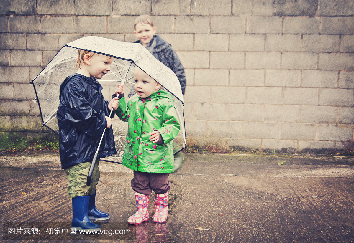 两个孩子在雨中分享一把伞