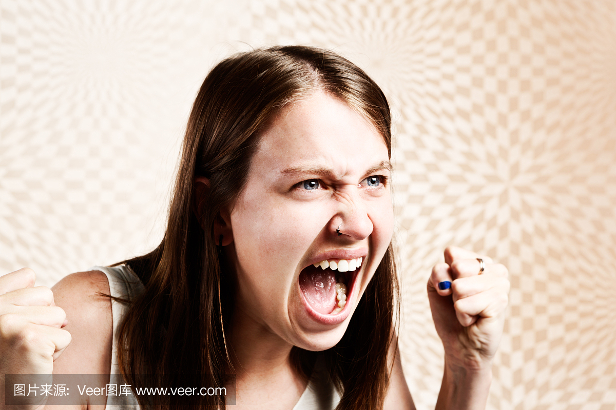 愤怒的握紧拳头的年轻女子大声疾呼